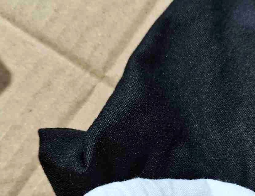 Anonymous close-up of fabric finish checked during a quality inspection