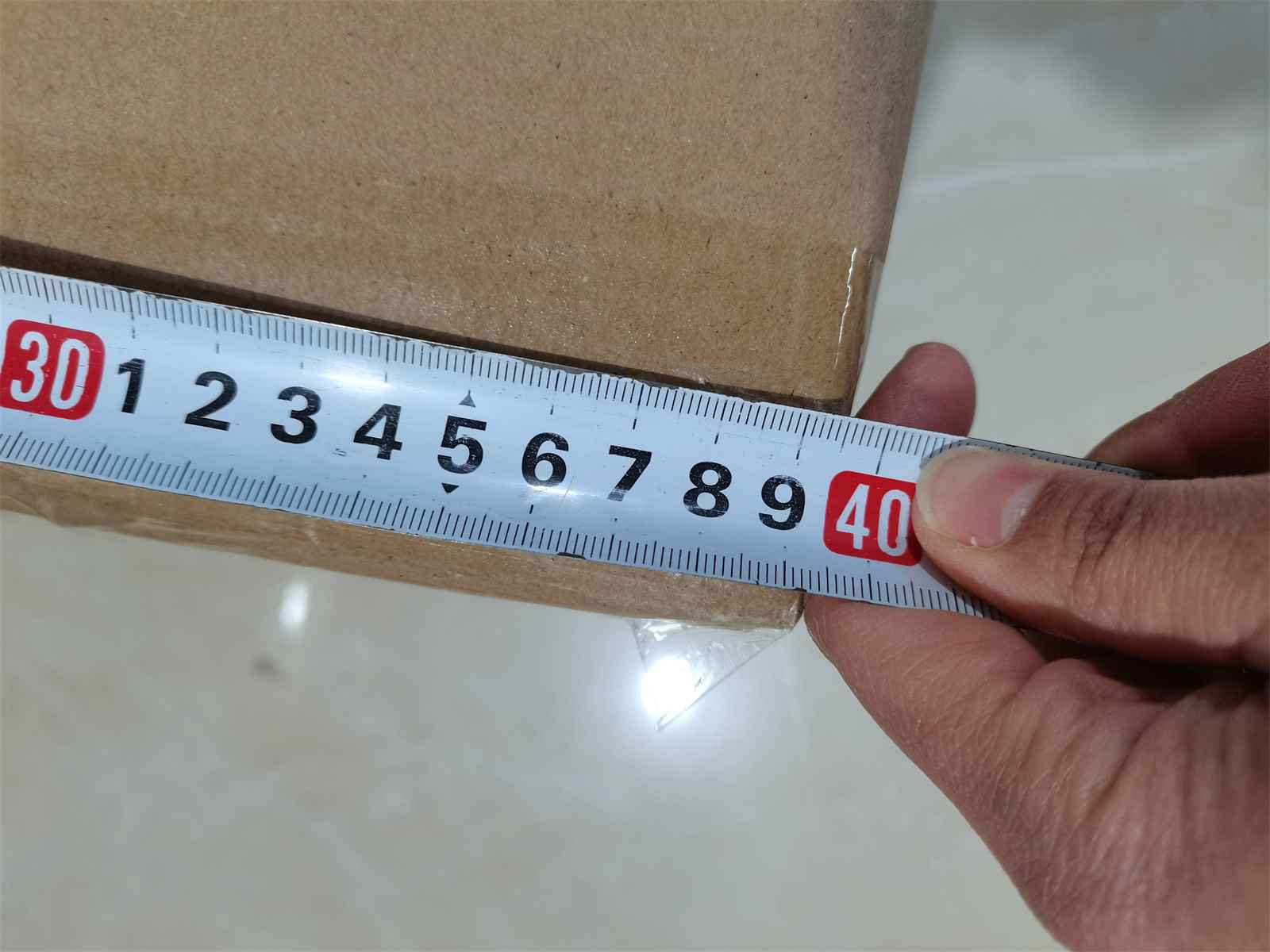 Inspector measuring a master carton during a China pre-shipment inspection
