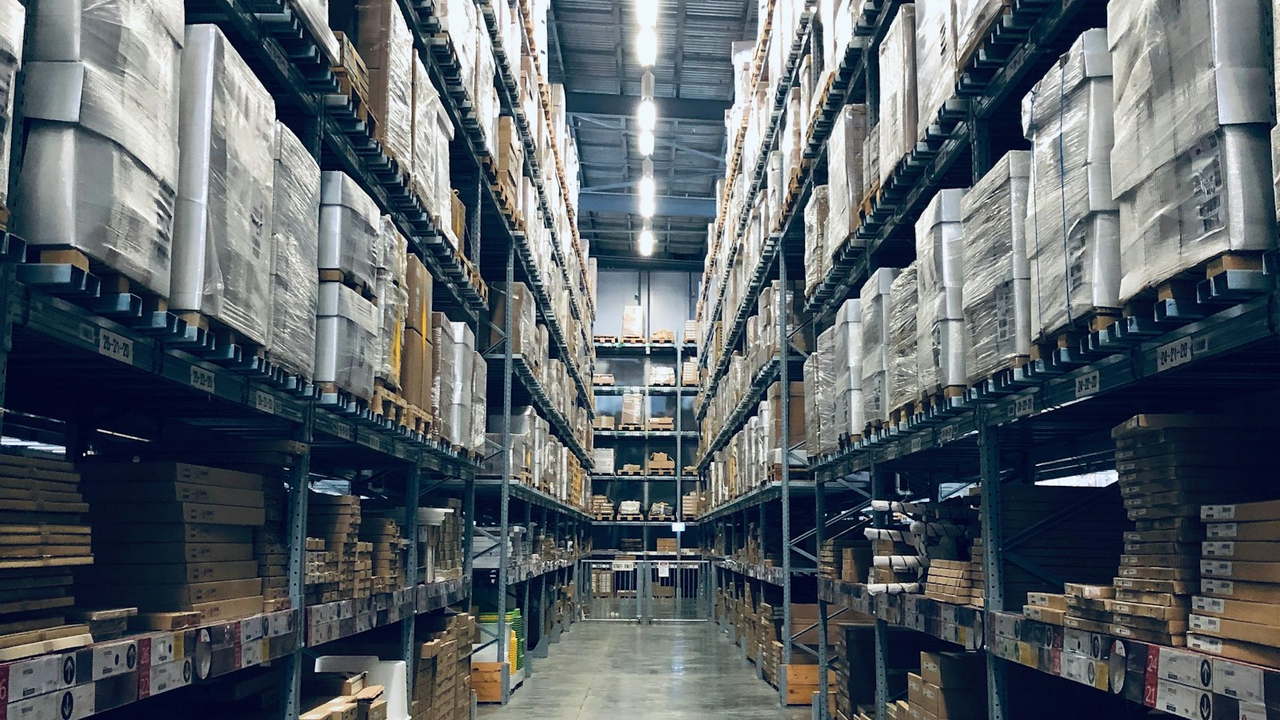 Warehouse aisle with outbound cartons on racks (illustrative)