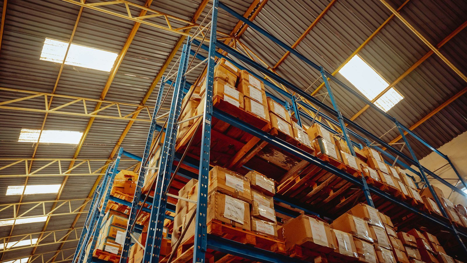 Labeled cardboard cartons stacked on warehouse rack pallets